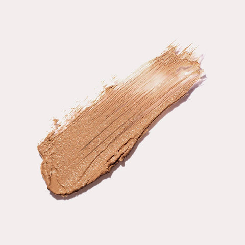 Ere Perez Arnica All-Cover Pot Brew swatch, a streak of warm caramel concealer, close up of the texture, clear product photo, single image