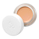 Ere Perez Arnica All-Cover Pot Chai 5g, an open white pot with its lid beside it showing warm peach tan concealer, front view on white