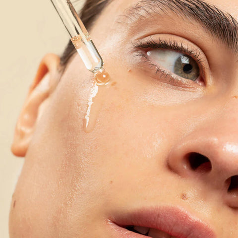Ere Perez Australian Blue Cypress Face Nectar 30ml lifestyle close up of a person's eye and cheek as oil drips from a dropper