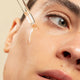 Ere Perez Australian Blue Cypress Face Nectar 30ml lifestyle close up of a person's eye and cheek as oil drips from a dropper
