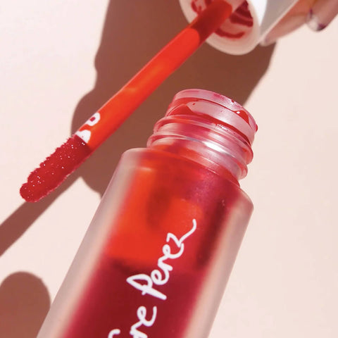 Close up of Joy beetroot cheek & lip tint showing applicator and product texture.