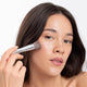 Ere Perez Eco Vegan Brush Multipurpose lifestyle shot of a woman with long dark hair using the brush on her cheek, styled lifestyle photo