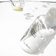 Clear bottle of Ere Perez ginkgo micellar cleanser 37g bottle with a droplet of liquid being poured into water.