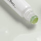 Closeup of Ere Perez Grape Water Eye Serum with a jade roller applicator.