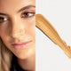 Ere Perez Oat Milk Foundation Caramel lifestyle split image of a woman with warm skin beside a swatch of golden tan foundation
