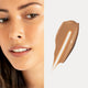 Ere Perez Oat Milk Foundation Maple lifestyle split image of a woman with warm skin beside a swatch of tan foundation, face cropped