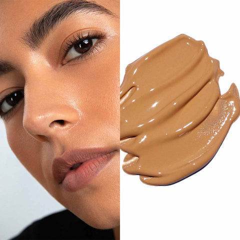 Close-up of a woman's face with a swatch of brown makeup product.
