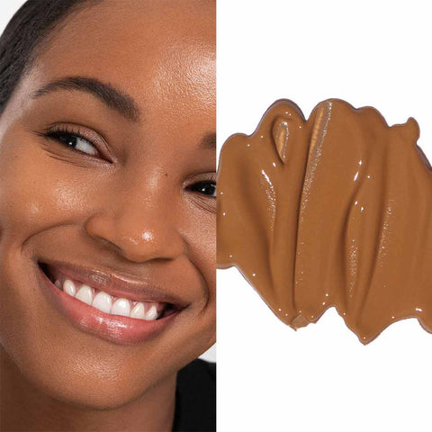 Close-up of a woman's face with a swatch of brown makeup product.