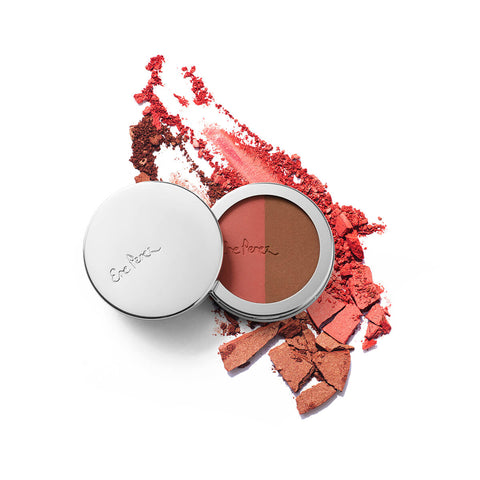 Ere Perez Rice Powder Blush & Bronzer Brooklyn 9g compact beside crushed coral and red powder, swatch shot on white, clear product photo