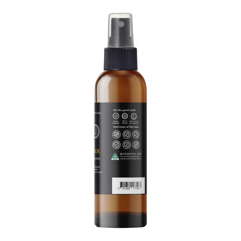 Brown spray bottle with black label on a white background.