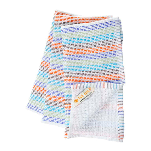 A folded waffle-weave dish cloth with multicolour stripes in blue, orange, purple, and green on a white background, with the brand tag 'full circle' visible.