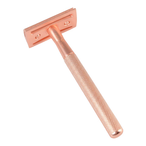 Rose gold safety razor on a white background.