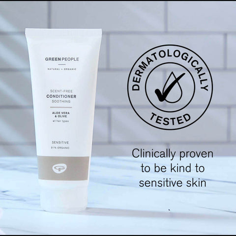 Tube of Green People conditioner with dermatologically tested logo and text on a blurred background.