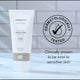 Tube of Green People conditioner with dermatologically tested logo and text on a blurred background.