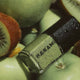 Nail polish with 'HANAMI' branding on a kiwi fruit background