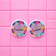 Two Hanami nail polish remover containers on a pink tiled background.