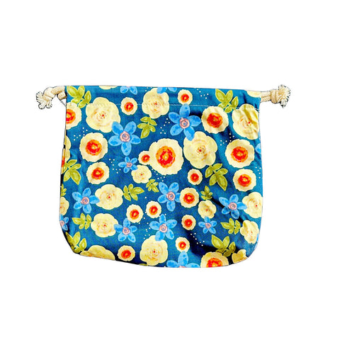 hannah Waterproof Wet Bag Blue Yellow Flowers, a bright blue drawstring bag printed with yellow and red flowers on a plain white background