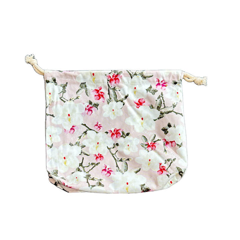 hannah Waterproof Wet Bag Pink Flowers, a white drawstring bag printed with pink blossom on a plain white background, clear product photo