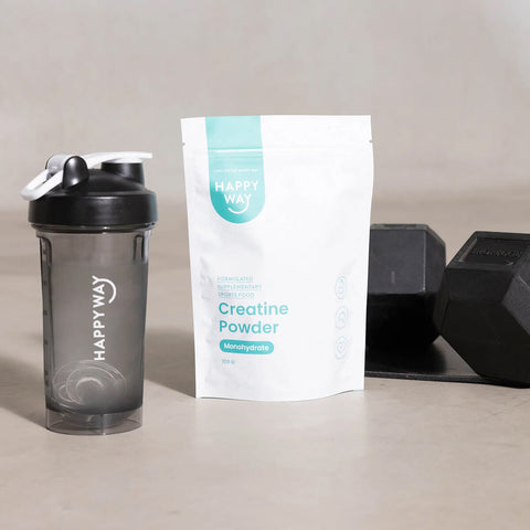 Happy Way creatine powder on bench next to branded smoothie cup and weights