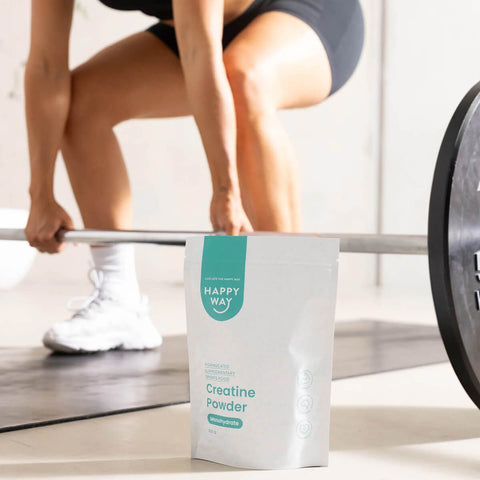 Happy Way creatine powder resealable pouch in front of a cropped view of a person lifting weights