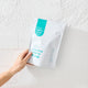 Happy Way creatine powder pictured against painted white brick wall 