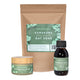 Honest Skincare Kawakawa Balm Healing Gift Set a kraft pouch of colloidal oat soak, a balm jar and an oil bottle with green labels on white