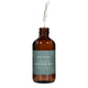 Honest Skincare Organic Castor Oil 250ml open amber bottle with its dropper lifted and a drop falling on a plain white background