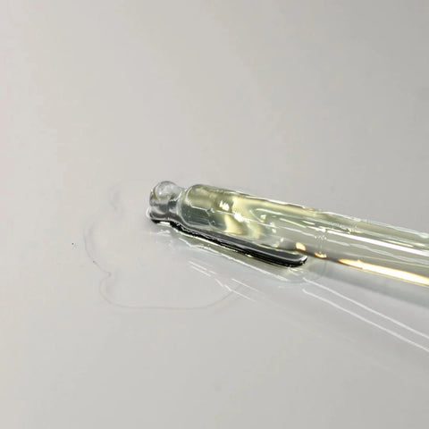 Honest Skincare Organic Jojoba Oil 250ml lifestyle close up of a glass dropper with a drop of oil, styled lifestyle photo, single image