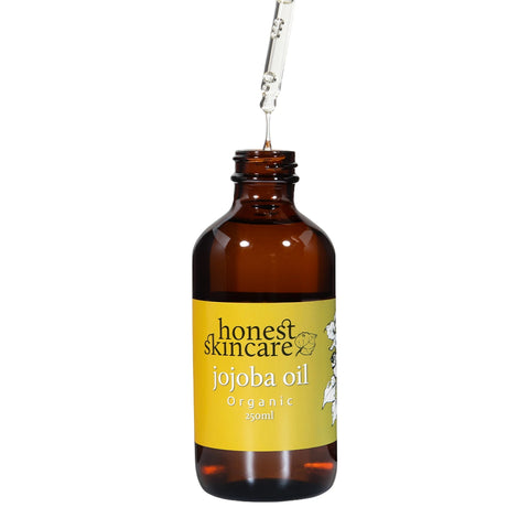 Honest Skincare Organic Jojoba Oil 250ml open amber bottle with its dropper lifted, front view on a plain white background, clear product photo