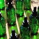 Honest Skincare Organic Rosemary Revitalising Hair Serum 100ml lifestyle close up of rows of green glass dropper bottles, styled lifestyle photo