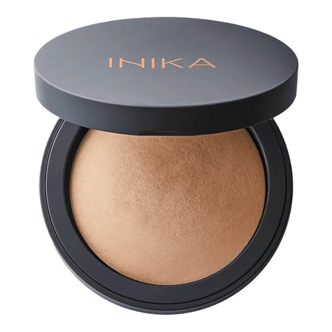 INIKA Organic Baked Mineral Foundation 8g shade Patience per file name, open compact with a grey lid above a golden beige pressed powder on white
