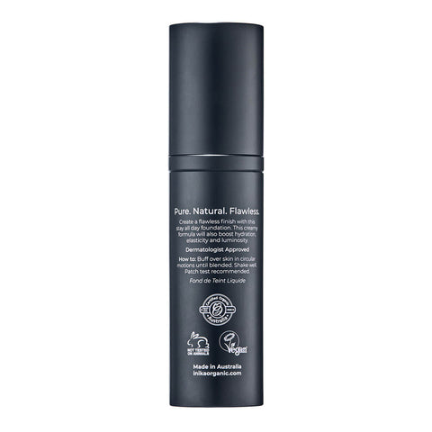 Back of black bottle of INIKA Organic Liquid Foundation on a white background.