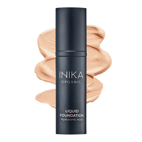 Bottle of INIKA Organic Liquid Foundation with a beige-coloured swatch behind it.