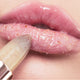Close-up of lip scrub on lips, flecks of toffee-coloured sugar particles & glossy finish.