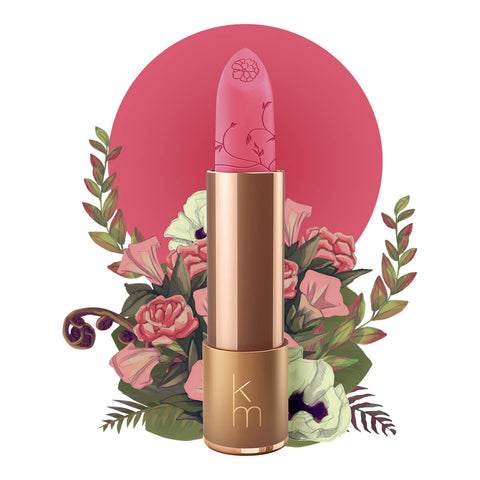 Lipstick detailed with vines & a flower on the tip, set against a floral background.