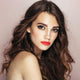 Young woman with pale olive skin tone & brunette hair wearing rymba rhythm lipstick.