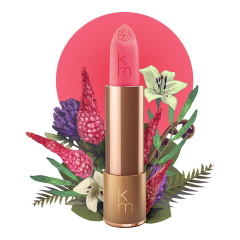 Lipstick detailed with KM initials & flower on the tip, set against a floral background. 