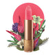 Lipstick detailed with KM initials & flower on the tip, set against a floral background. 
