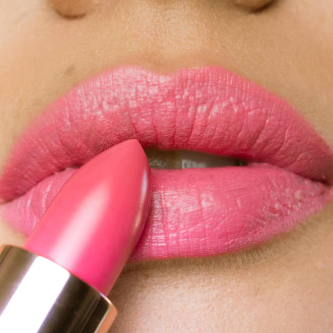 Close-up of a woman applying camellia morning lipstick.