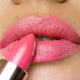 Close-up of a woman applying camellia morning lipstick.