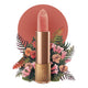 Lipstick detailed with KM initials & flower on the tip, set against a floral background. 