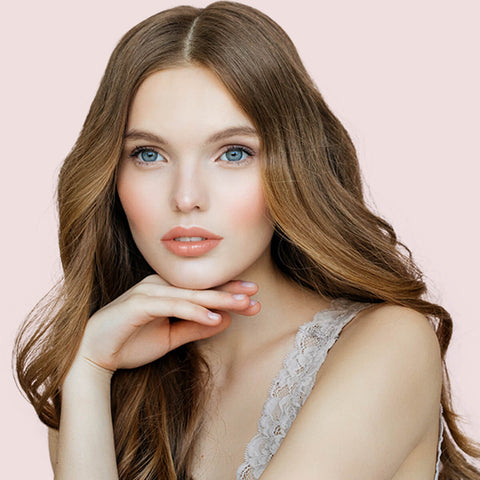 Young woman with fair skin tone & dark blonde hair wearing orchid bloom lipstick.