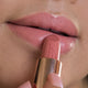 Close-up of orchid bloom lipstick applied on the lips. 