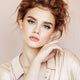 Young woman with fair, freckly skin tone & red hair wearing peony petal lipstick.