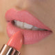 Close-up of peony petal lipstick applied on the lips. 