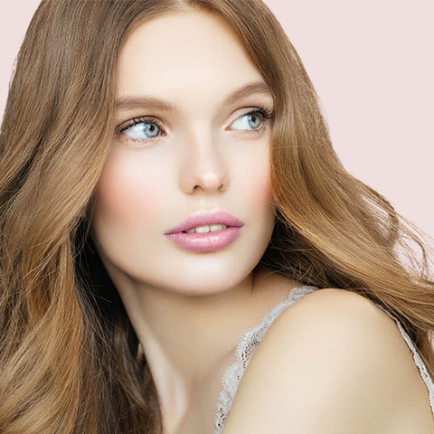Young woman with fair skin tone & dark blonde hair wearing lavender laughter lipstick.