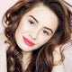Young woman with fair skin tone & brunette hair wearing poppy passion lipstick.