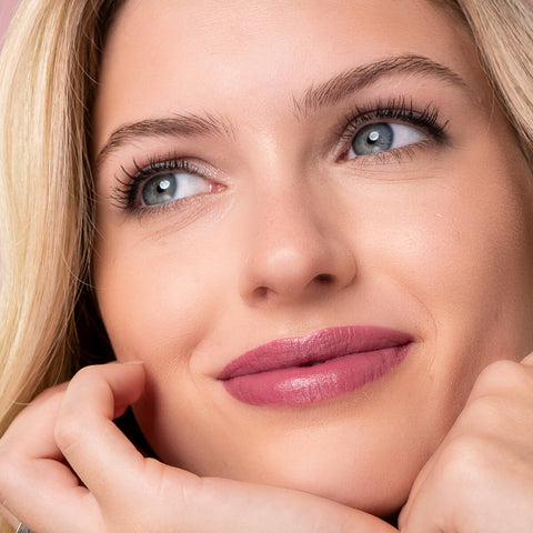 Young woman with light skin tone & blonde hair, wearing driven lipstick.