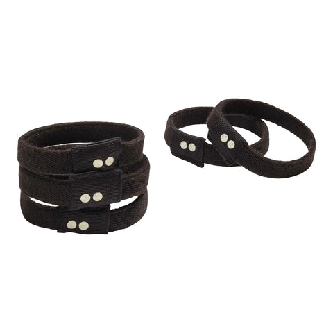Set of black wristbands with silver buttons on a white background