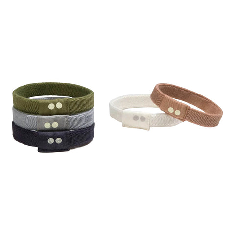 Set of five fabric wristbands in various colors on a white background